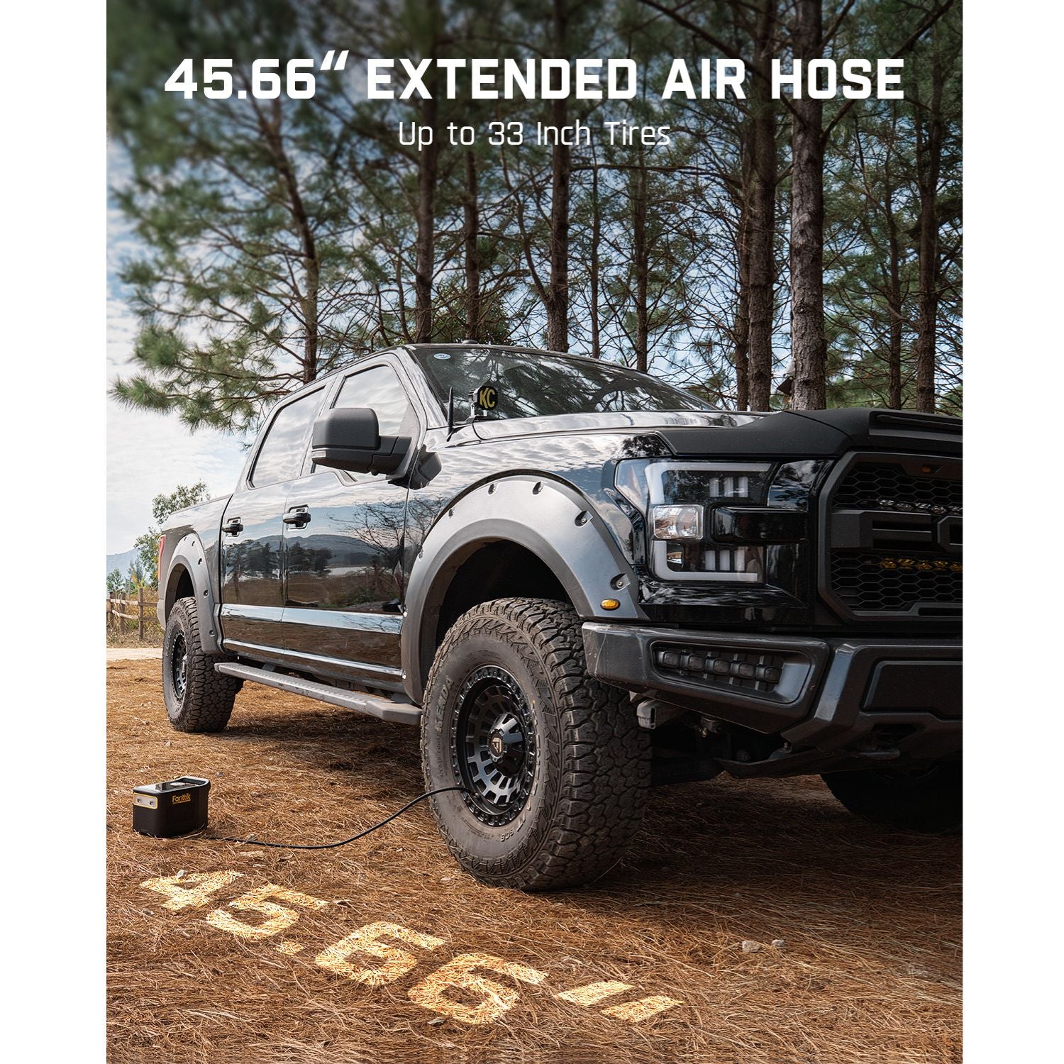 Truck with Fanttik X9 Ultra™ Tire Inflator, featuring a 45.66-inch extended air hose for up to 33-inch tires in a wooded area