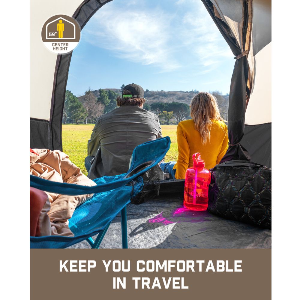Couple sitting inside the FanttikOutdoor Zeta C4 Pro 4 Person Camping Tent looking at an outdoor view, surrounded by camping gear. Text overlay reads 'KEEP YOU COMFORTABLE IN TRAVEL' and an icon shows a 59-inch center height.