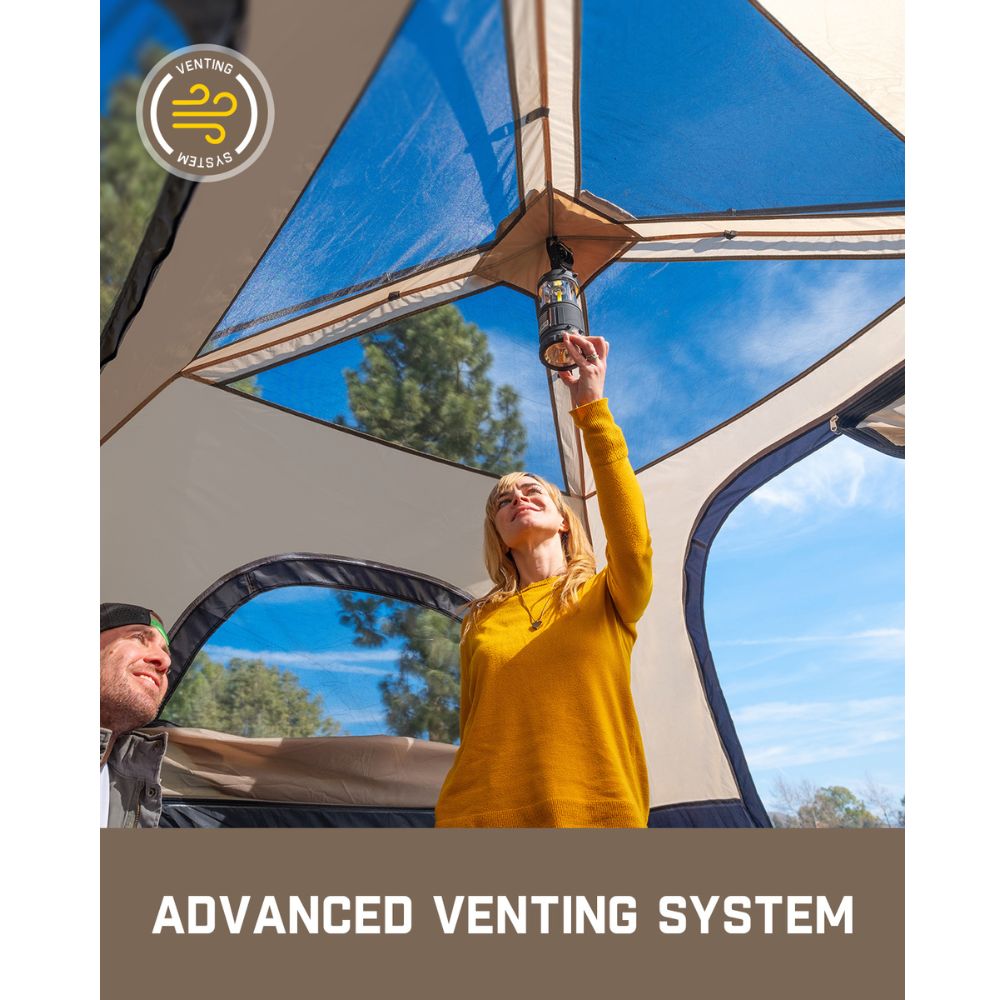 Two people demonstrating the advanced venting system in a FanttikOutdoor Zeta C4 Pro 4 Person Camping Tent, with large mesh panels and a person holding a lantern.