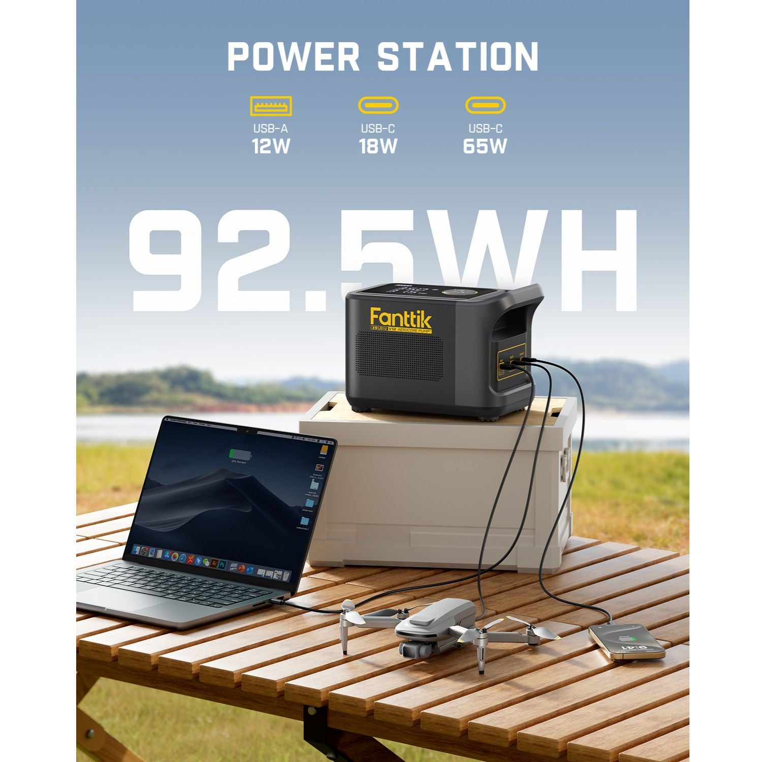 Fanttik portable power station with 92.5WH capacity, featuring USB-A 12W, USB-C 18W, and USB-C 65W ports, shown charging a laptop and drone outdoors by a lake.