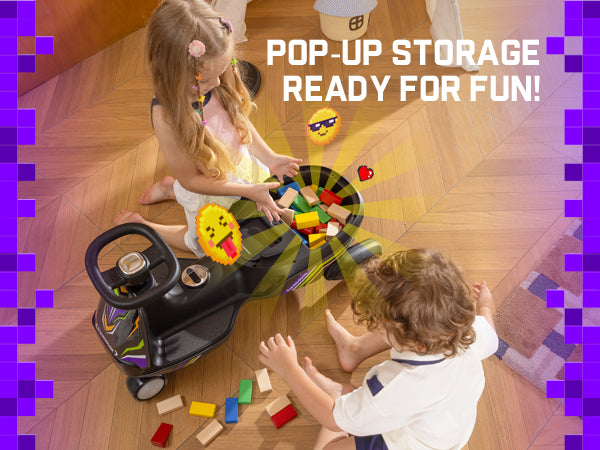 A child's ride-on toy car with a pop-up storage basket on a wooden floor, being played with by two children. The toy is black with green and yellow striped pop-up storage compartments filled with colorful blocks.
