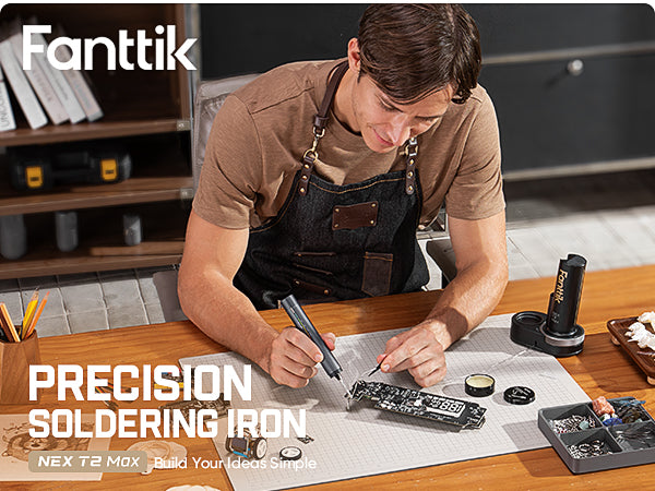A man sits at a table soldering a circuit board using the Fanttik T2 Max Cordless Soldering Iron Kit.