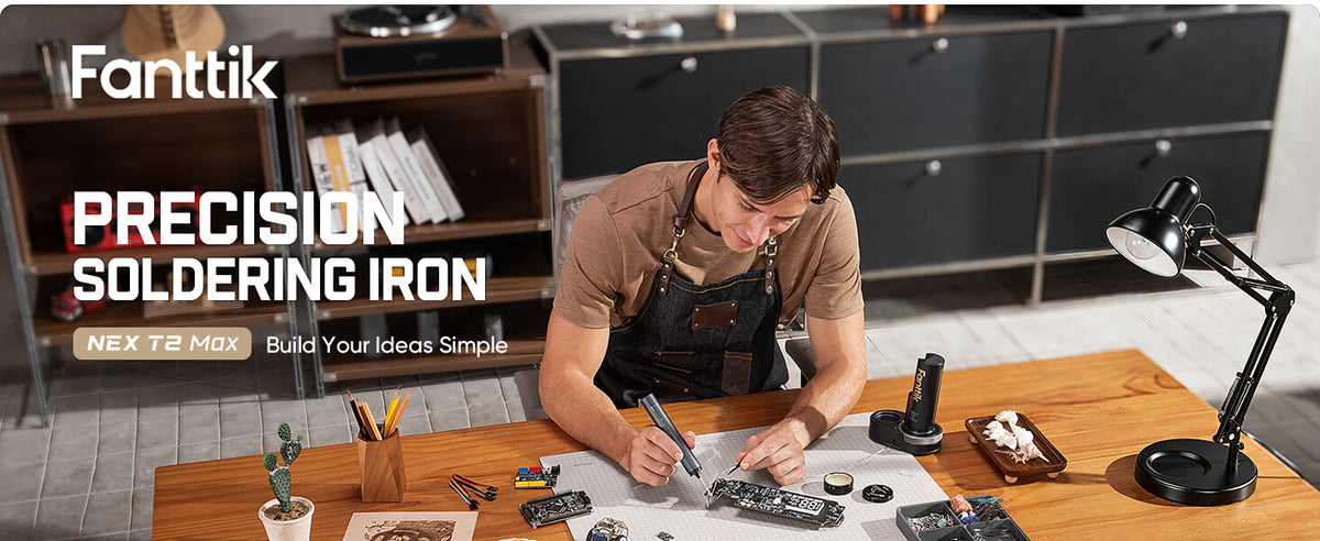 A man sits at a table soldering a circuit board using the Fanttik T2 Max Cordless Soldering Iron Kit.