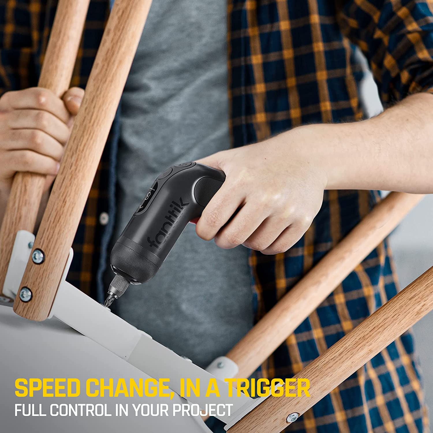 Person using Fanttik NEX L1 Pro cordless screwdriver for assembling wooden furniture, highlighting speed change trigger and full control.