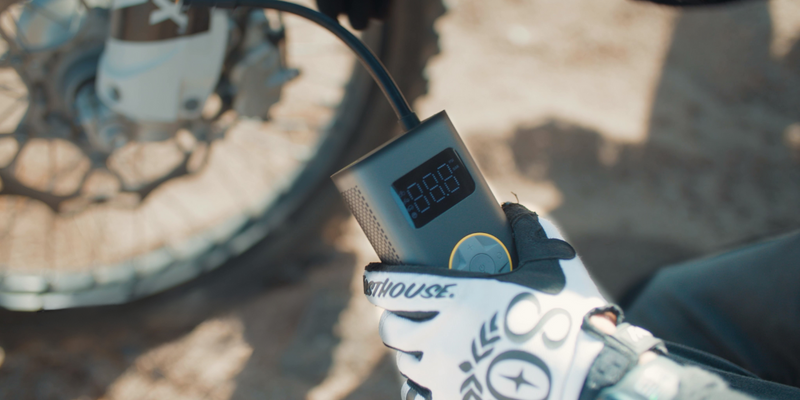 Close-up of a digital tool interface showing voltage and status indicators for automotive maintenance.