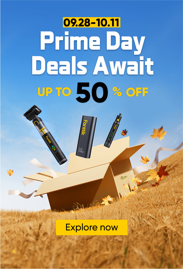 Promotional banner for Prime Day deals featuring three black and yellow Trekking Paks portable power banks emerging from an open cardboard box on a grassy hill under a blue sky with falling autumn leaves. Text on the left reads '09.