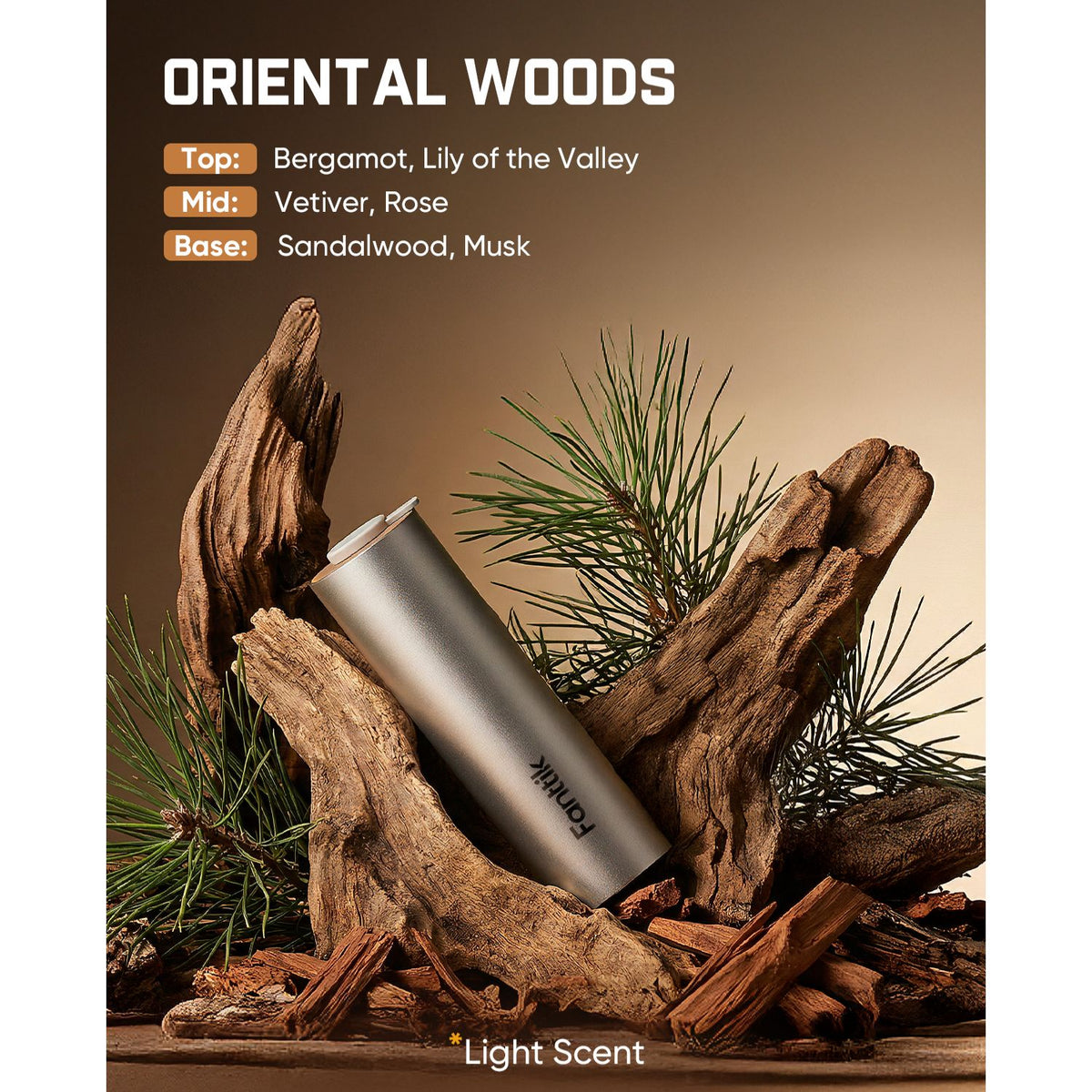 A silver cylindrical perfume bottle labeled 'Famuhk' displayed diagonally among driftwood, pine needles, and wood chips on a brown background, with text reading 'ORIENTAL WOODS' and scent notes.