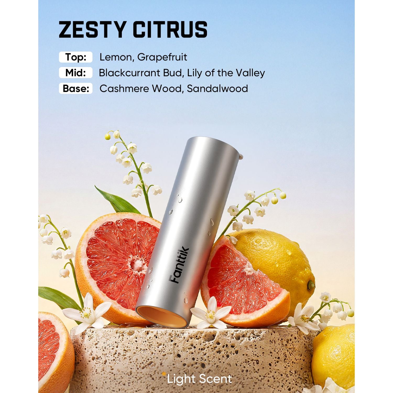 A silver cylindrical fragrance diffuser labeled Fantik stands upright on a stone pedestal with citrus slices, lemons, and white flowers. Text at the top reads 'ZESTY CITRUS' with scent notes, and 'Light Scent' appears at the bottom.