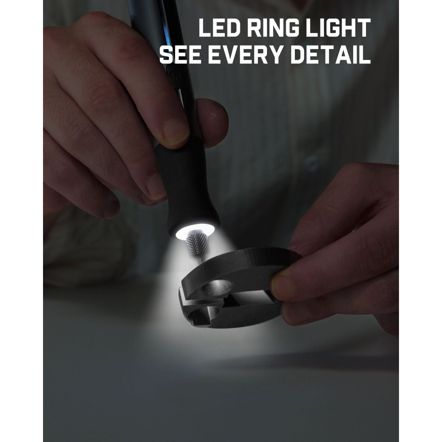 A close-up of a person holding a black LED ring light and shining a bright beam of light onto a metal clip to demonstrate its use. White text at the top reads 'LED RING LIGHT SEE EVERY DETAIL'.