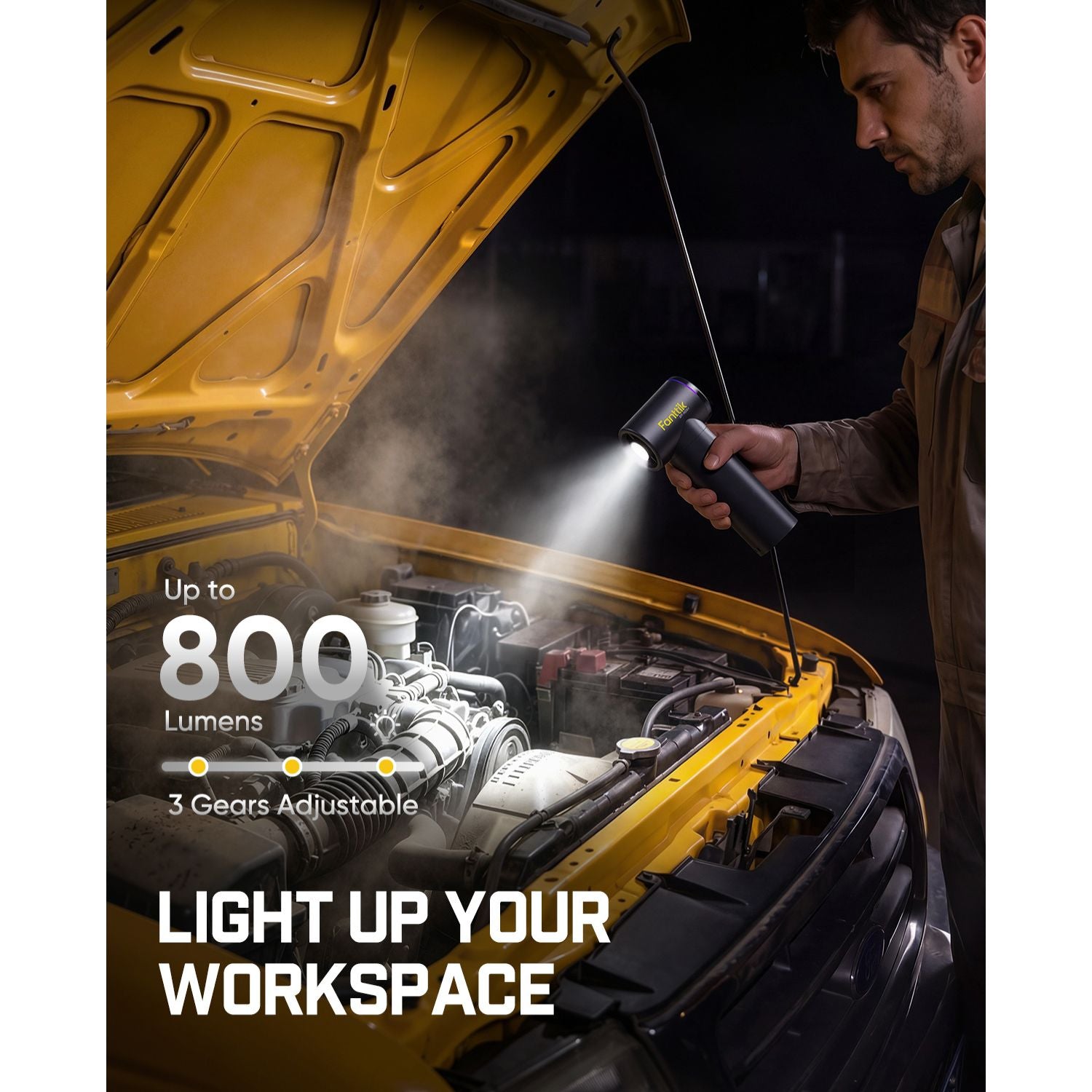 Person using a flashlight under a car with text highlighting features.