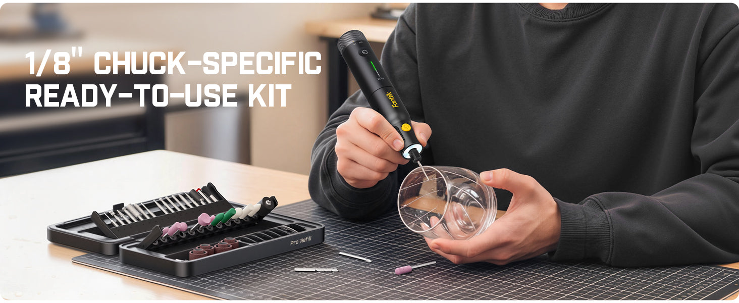 A person using a Rotary Tool over a small clear glass container on a dark cutting mat, with an open black tool case and small components nearby. White text in the upper left reads '1/8" CHUCK-SPECIFIC READY-TO-USE KIT'.