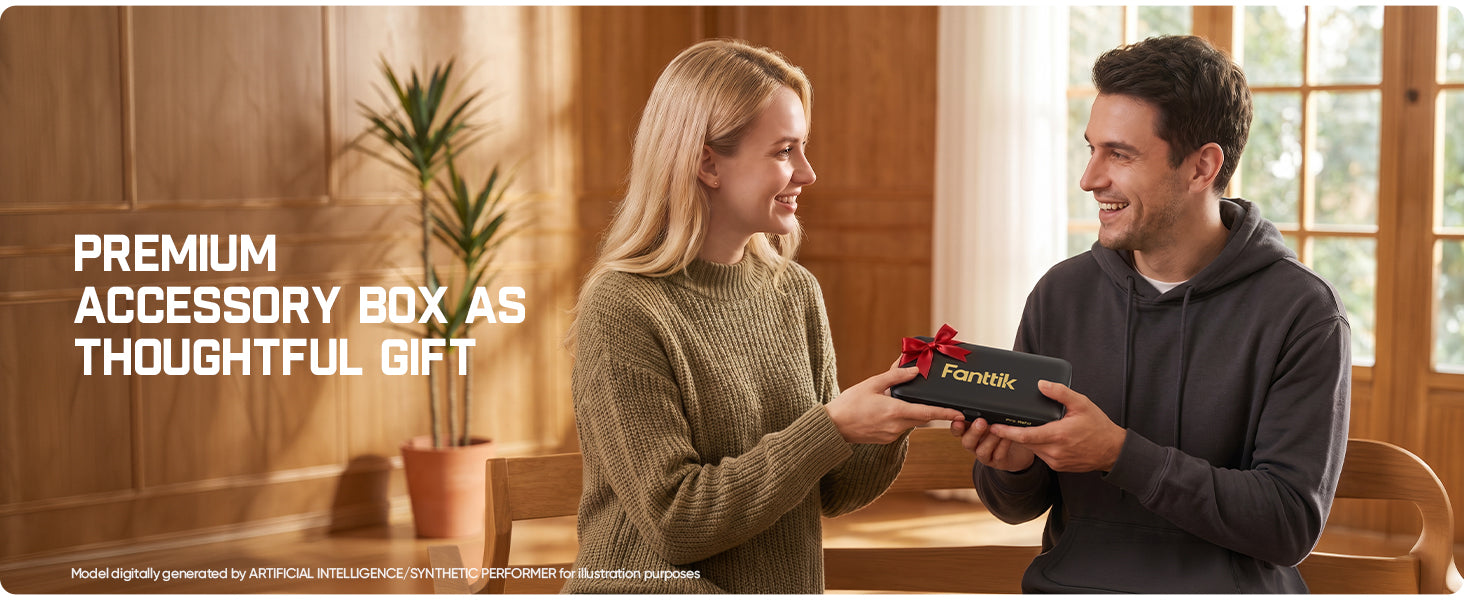A man and a woman smiling as the woman presents a black Fanttik gift box with a red ribbon to the man in a warm, wood-paneled room. Large white text at the top reads 'PREMIUM ACCESSORY BOX AS THOUGHTFUL GIFT'.