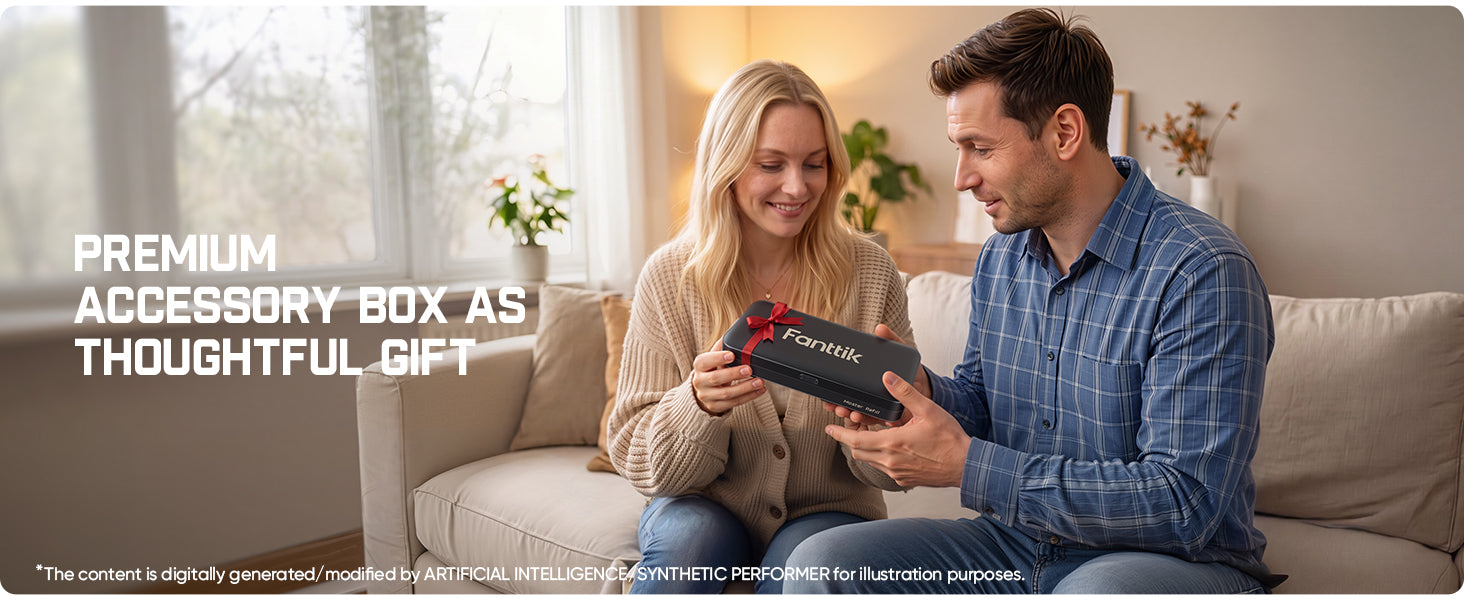 A man and a woman sitting on a beige sofa in a living room setting, looking at a black gift box with a red ribbon and the brand name 'Fanttik' visible on the front. White text on the left reads 'PREMIUM ACCESSORY BOX AS THOUGHTFUL GIFT'.