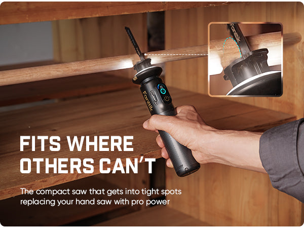 A person holds a compact cordless saw with a built-in LED light under a wooden shelf. The image includes marketing text reading 'FITS WHERE OTHERS CAN'T' and a small inset showing the screwdriver tip in close-up.