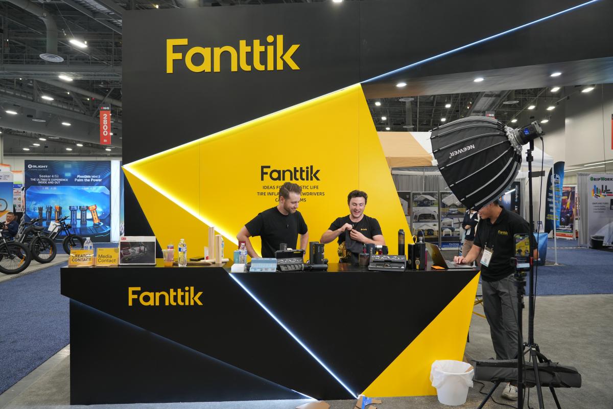 Fanttik booth at a trade show with branding and products on display.