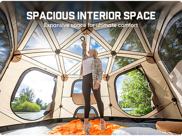 A woman stands inside a spacious geodesic-style camping tent, with large windows showing an outdoor forest scene. White text at the top reads 'SPACIOUS INTERIOR SPACE' and 'Expansive space for ultimate comfort.